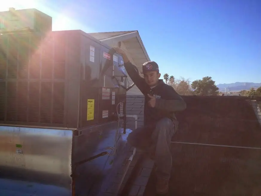 HVAC technician performing HVAC Inspection on a rooftop unit in Bel Air South